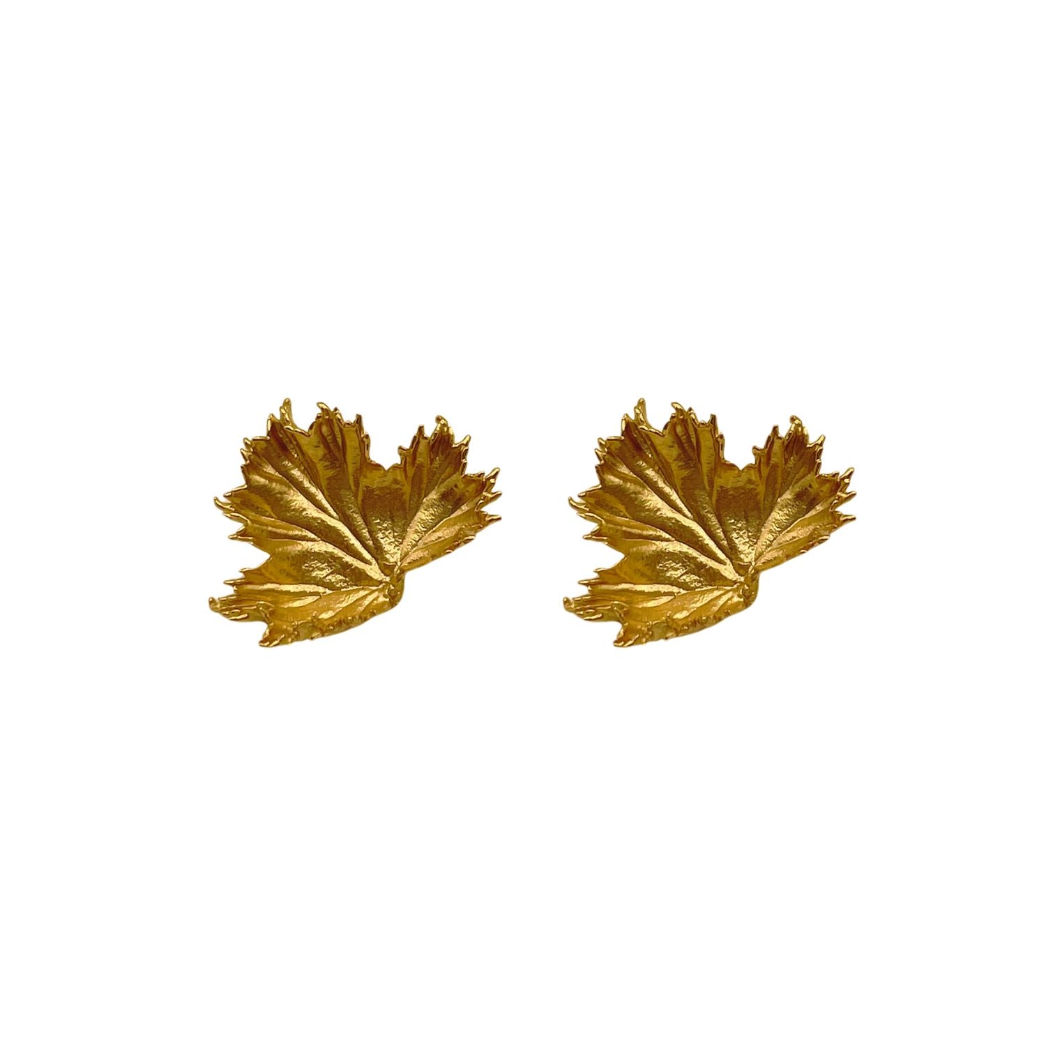 Gold leaf-shaped earrings on a white background