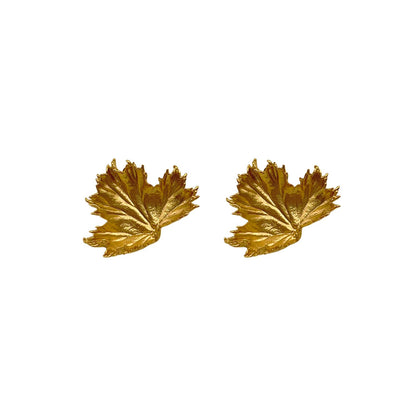 Gold leaf-shaped earrings on a white background